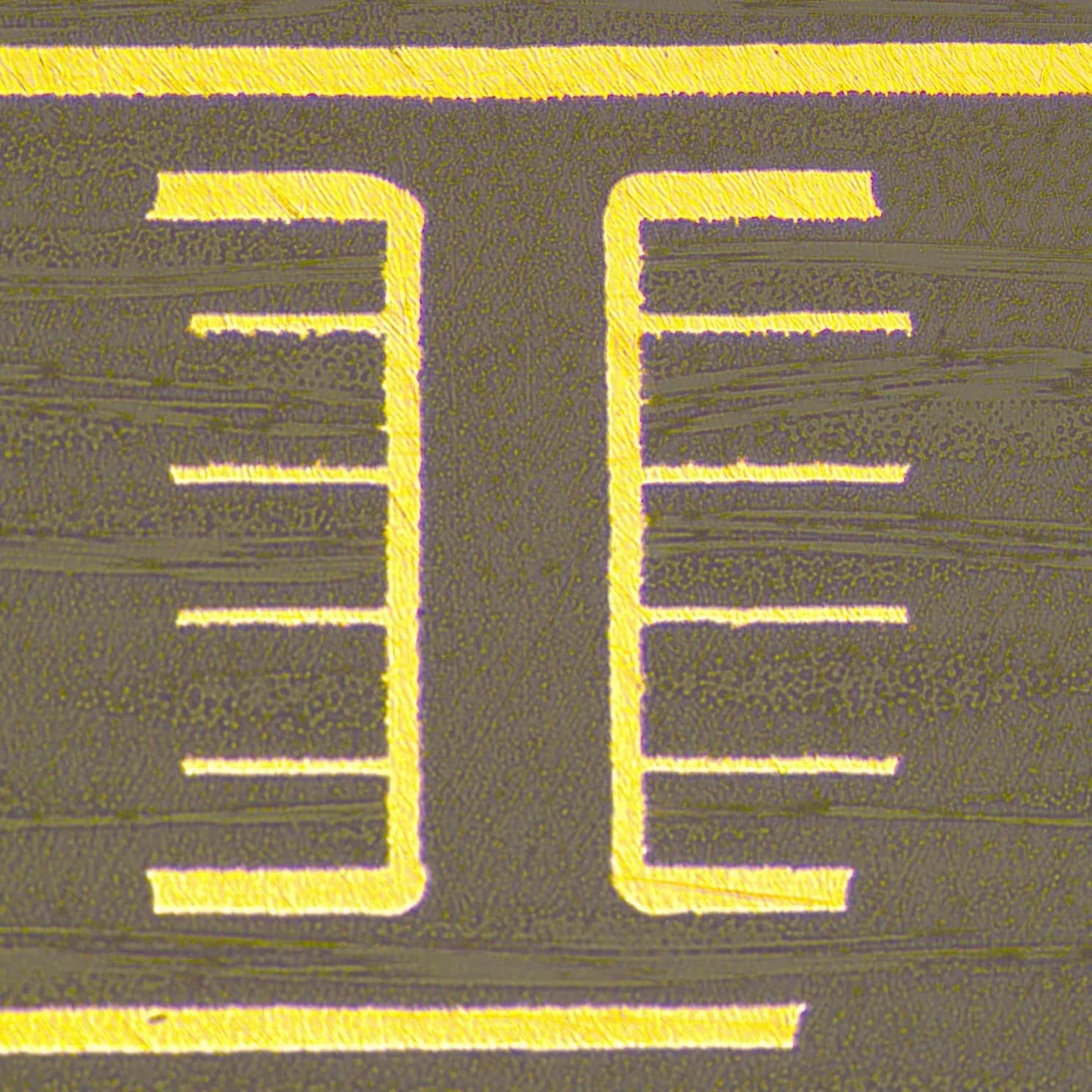 High-magnification microscopic cross-section of a copper-plated blind via connecting external to internal PCB layers.
