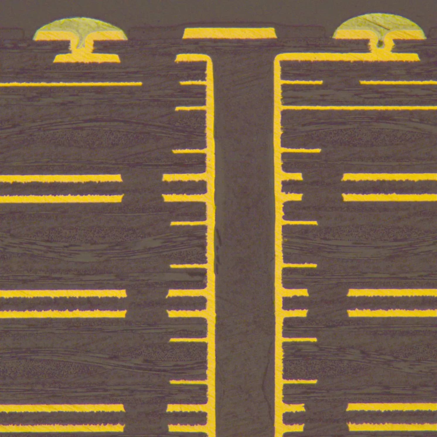 Microscopic cross-section of a buried via completely filled with conductive resin and capped with copper plating.