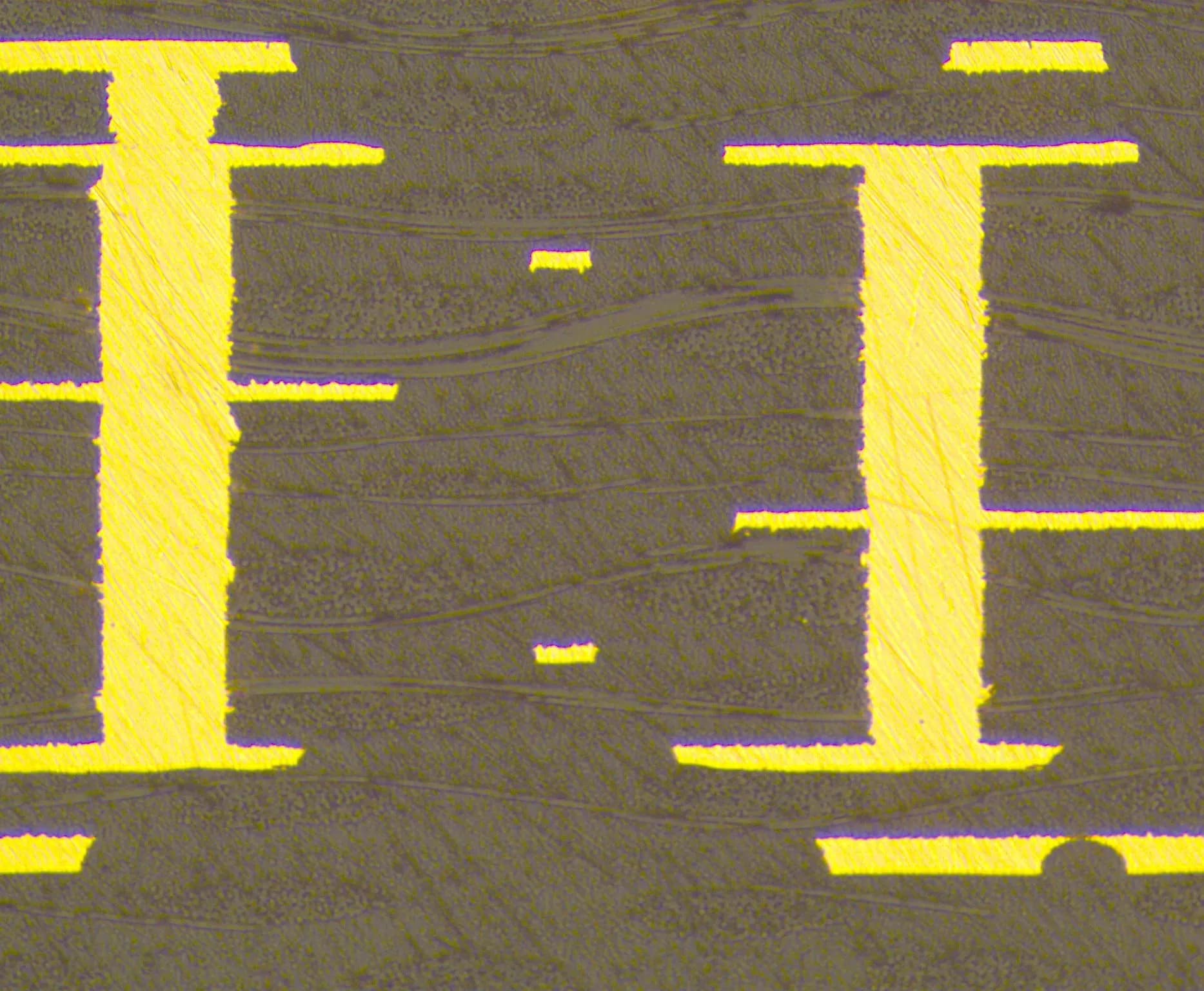 Microscopy cross-section of copper-filled buried vias interconnecting internal PCB trace layers, demonstrating reliable copper deposition with no surface connection at either end.