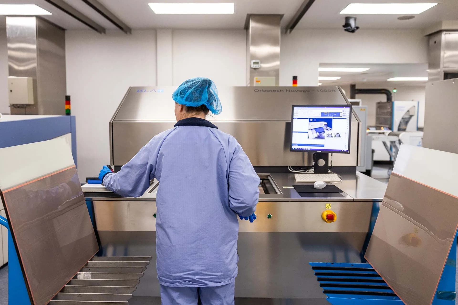 Exception PCB operator at the Orbotech Nuvogo 1000R laser direct imaging system in the cleanroom imaging area at the Tewkesbury facility