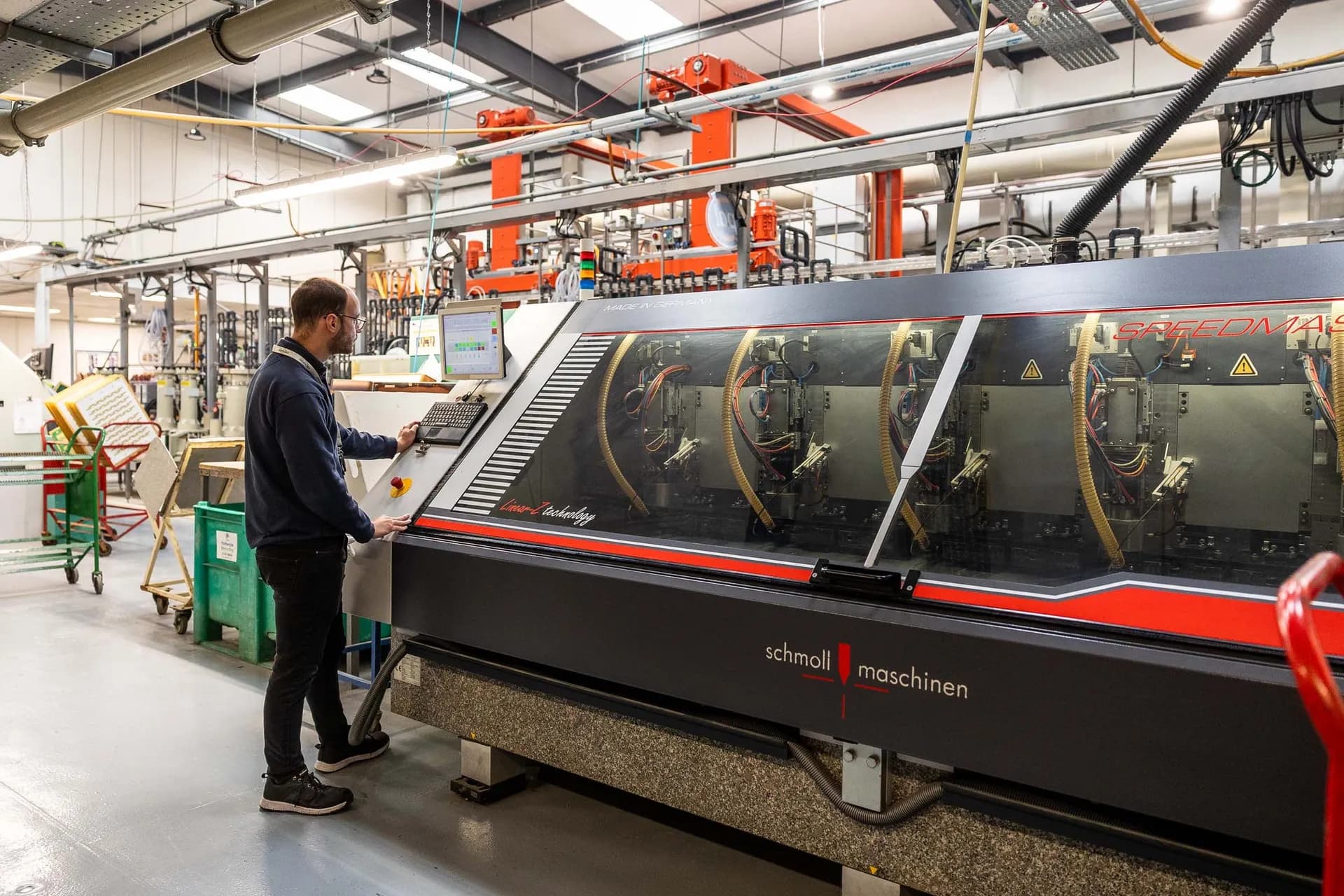 Exception PCB operator at the Schmoll Speedmaster six-station PCB drilling machine at the Tewkesbury manufacturing facility