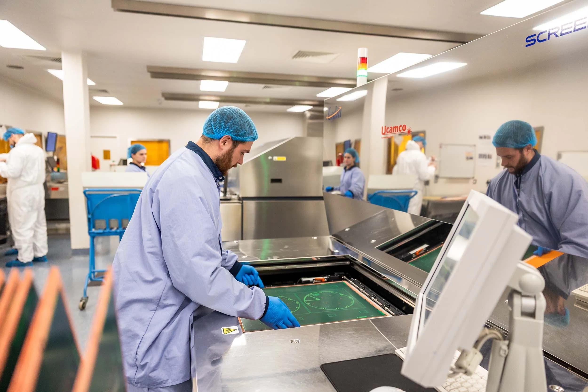 Exception PCB technicians working in a clean PCB manufacturing area at the company’s UK facility in Tewkesbury.
